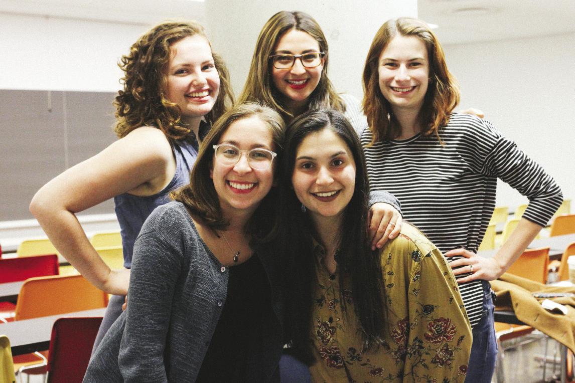 5 women in a classroom looking straight at the viewer