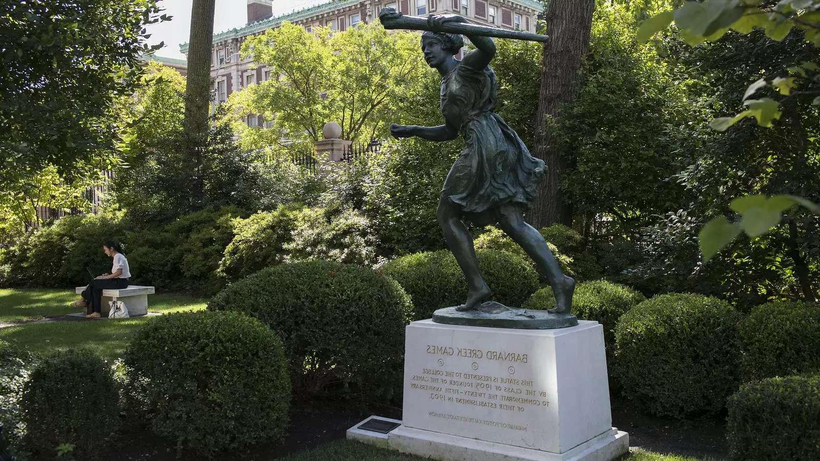 statue of a woman running in a shady green space on Barnard's campus