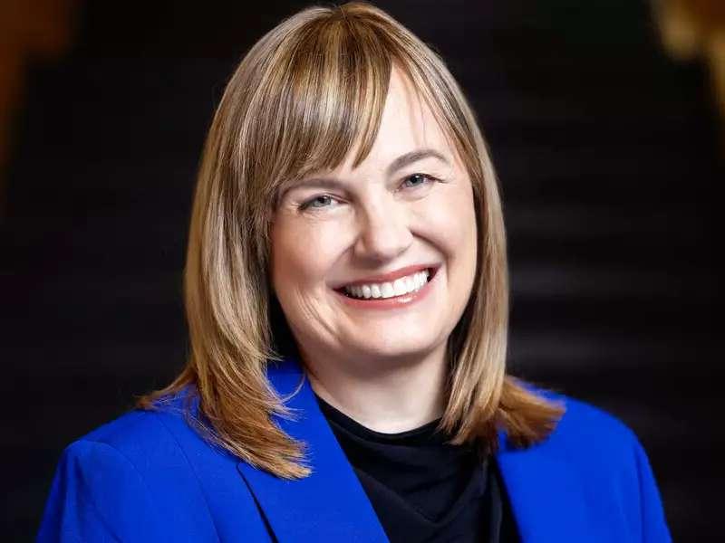 Laura Rosenbury wearing a bright blue blazer, smiling